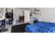 Cozy bedroom with a blue plaid comforter, electric fireplace, and spacious closet at 1610 Meadow Ne Ln, Winter Haven, FL 33881