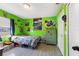 Vibrant green bedroom with a fun race car theme at 1610 Meadow Ne Ln, Winter Haven, FL 33881