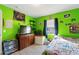 ' bedroom with bright green walls and ample storage at 1610 Meadow Ne Ln, Winter Haven, FL 33881