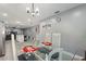 Dining room with glass-top table and chairs, open to the kitchen at 1610 Meadow Ne Ln, Winter Haven, FL 33881