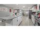 Open concept kitchen with granite island, stainless steel appliances, and gray cabinets at 1610 Meadow Ne Ln, Winter Haven, FL 33881