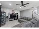 Open living area with grey sectional sofa and built-in entertainment center at 1610 Meadow Ne Ln, Winter Haven, FL 33881
