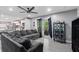 Spacious living room featuring a large sectional sofa and access to a backyard patio at 1610 Meadow Ne Ln, Winter Haven, FL 33881