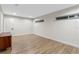 Bright bedroom featuring wood-look floors and neutral walls at 1814 Lake Ariana Blvd, Auburndale, FL 33823