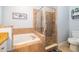 Bathroom with walk-in shower, soaking tub, and granite countertop at 2060 Hemingway Ave, Haines City, FL 33844