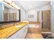 Elegant bathroom with granite countertops, soaking tub, and walk-in shower at 2060 Hemingway Ave, Haines City, FL 33844