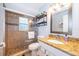 Clean bathroom with granite countertop, walk in shower, and built in shelving at 2060 Hemingway Ave, Haines City, FL 33844