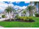 Light blue house with palm trees, two-car garage, and well-manicured lawn at 2060 Hemingway Ave, Haines City, FL 33844