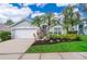 Beautiful house with a two-car garage and manicured lawn at 2060 Hemingway Ave, Haines City, FL 33844