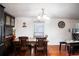 Dining room features wood table, four chairs, and a clock at 2419 Trenton E Rd, Lakeland, FL 33815