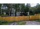 Mobile home with wooden fence and gated entrance at 2419 Trenton E Rd, Lakeland, FL 33815