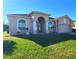 One story house with a well-manicured lawn and an attached garage at 2712 Oak Hammock Loop, Mulberry, FL 33860