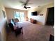 Bright living room featuring sliding glass doors and a ceiling fan at 2712 Oak Hammock Loop, Mulberry, FL 33860