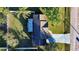 Aerial view of a house with a gray roof, driveway, and yard at 315 Lauderdale Ct, Kissimmee, FL 34759