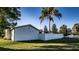 Large backyard with a white vinyl fence and a mature palm tree at 315 Lauderdale Ct, Kissimmee, FL 34759