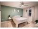 Serene bedroom with a tranquil green accent wall and a comfortable bed at 315 Lauderdale Ct, Kissimmee, FL 34759