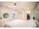 Spacious bedroom with a ceiling fan, ample closet space, and a view of the kitchen at 315 Lauderdale Ct, Kissimmee, FL 34759
