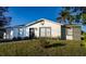 Newly renovated home exterior with gray driveway and green landscaping at 315 Lauderdale Ct, Kissimmee, FL 34759