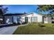 House exterior, freshly painted, featuring a gray driveway and landscaping at 315 Lauderdale Ct, Kissimmee, FL 34759
