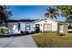 Charming single story home with a landscaped lawn and attached garage at 315 Lauderdale Ct, Kissimmee, FL 34759