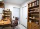 Functional home office with built-in shelving, a large desk, and comfortable chair at 315 Lauderdale Ct, Kissimmee, FL 34759