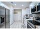 Updated kitchen with stainless steel appliances and white cabinets at 315 Lauderdale Ct, Kissimmee, FL 34759