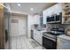 Modern kitchen featuring stainless steel appliances and white cabinetry at 315 Lauderdale Ct, Kissimmee, FL 34759