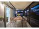 Screened patio with wooden dining table and chairs, ideal for outdoor dining at 315 Lauderdale Ct, Kissimmee, FL 34759
