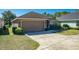 Front view of house with garage and landscaping at 4027 Island Lakes Dr, Winter Haven, FL 33881