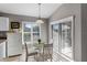 Charming breakfast nook with glass-top table and white chairs, near sliding doors at 4092 Carteret Dr, Winter Haven, FL 33884