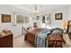 Bedroom with a queen bed, brown and teal bedding, and ceiling fan at 422 21St Sw St, Winter Haven, FL 33880