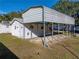 Side view of metal carport attached to a white building at 422 21St Sw St, Winter Haven, FL 33880