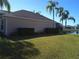 Spacious backyard with grassy area, hedges, and partial water view at 4329 Whistlewood Cir, Lakeland, FL 33811