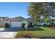 Single-story home with a two-car garage and mailbox at 817 Carlton Ct, Winter Haven, FL 33884