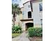 View of the building's exterior with stairs and lush landscaping at 820 Camargo Way # 108, Altamonte Springs, FL 32714