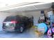 Garage with car, shelving, and various storage items at 858 Channing St, Winter Haven, FL 33880