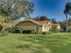 Single-story house with a landscaped lawn and mature trees at 1072 Old Cutler Rd, Lake Wales, FL 33898