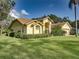 Charming yellow stucco home with mature landscaping at 1072 Old Cutler Rd, Lake Wales, FL 33898