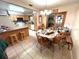 Dining area with a wooden table and chairs, and an adjacent kitchen with light wood cabinets at 128 Stevenson Rd, Winter Haven, FL 33884