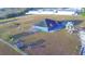 Aerial view of house, yard, and outbuildings at 135 Mi Rancho Rd, Davenport, FL 33837