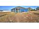 Charming home with a spacious backyard, patio, and fire pit at 135 Mi Rancho Rd, Davenport, FL 33837