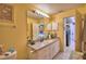 Guest bathroom with single vanity and access to kitchen at 135 Mi Rancho Rd, Davenport, FL 33837