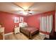 Cozy bedroom with double bed, nightstand, and window curtains at 135 Mi Rancho Rd, Davenport, FL 33837