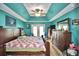 Spacious bedroom with teal ceiling and wood furniture at 135 Mi Rancho Rd, Davenport, FL 33837