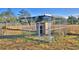 Metal dog kennel with shaded area at 135 Mi Rancho Rd, Davenport, FL 33837