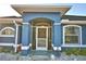 Blue house with a screened porch and white trim at 135 Mi Rancho Rd, Davenport, FL 33837