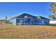 Ranch-style home with blue exterior and landscaping at 135 Mi Rancho Rd, Davenport, FL 33837