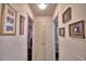 Hallway with framed photos and access to other rooms at 135 Mi Rancho Rd, Davenport, FL 33837