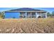 Blue house with solar panels and screened porch at 135 Mi Rancho Rd, Davenport, FL 33837
