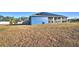 Blue house with solar panels and large yard at 135 Mi Rancho Rd, Davenport, FL 33837
